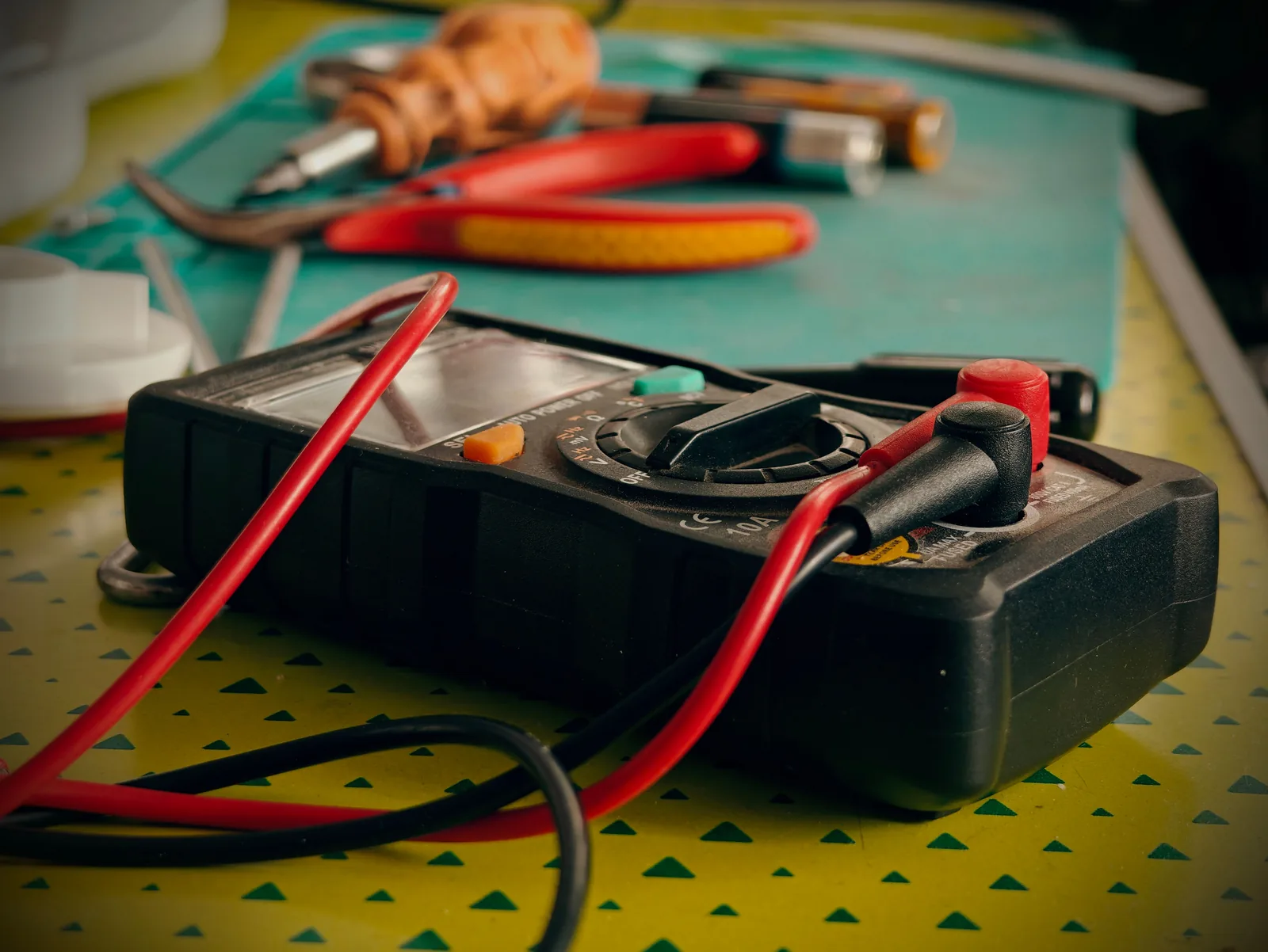 A multimeter and hand tools ready for a diagnostic visit, for electrician in Winnipeg