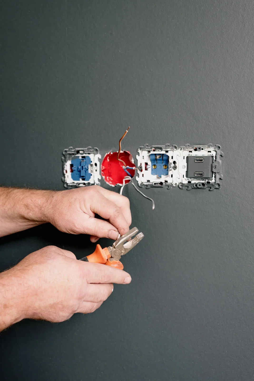 Wiring an outlet box into a finished wall, for code violation in Winnipeg