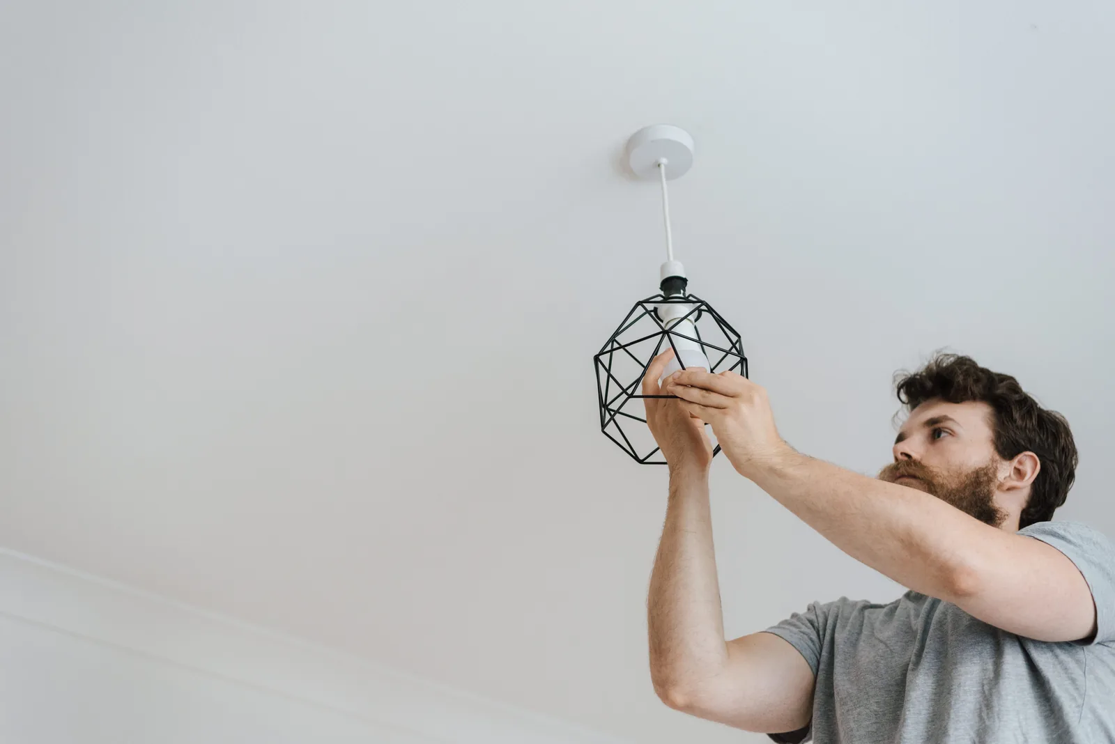 Fitting a lamp into a pendant fixture, for ev charger installation in Winnipeg